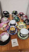 Front view showing assorted teacup and saucer pairs arranged on tabletop