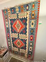 Full view of Kilim rug hanging on wall