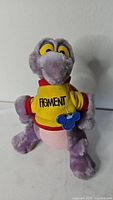 Front view of Figment plush wearing shirt and hang tag