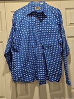 Full view of blue Barn Fly shirt hanging showing overall condition and pattern