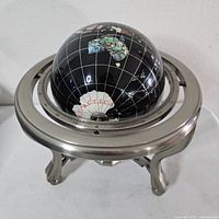 Full view of globe on brushed metal stand