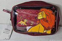 Front of cosmetic bag showing clear panel with Simba artwork and inner pouch