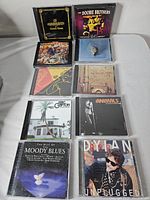 Nine CDs including Doobie Brothers, Clapton, Animals, Moody Blues, Dylan