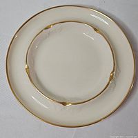 Top view showing entire ashtray, cream color, gold rim, leaf rests