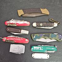 All nine pocket knives laid out