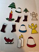 All fifteen stained glass ornaments laid out on surface