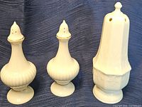 Three Lenox ivory china shakers front view