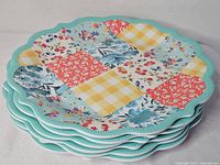 Stack of six patchwork melamine plates, side view