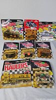 Full lot of nine sealed Racing Champions die-cast packages