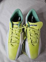 Top view of both cleats showing laces, tags and branding