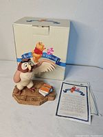 Front view of Owl figurine on base with book, box and insert visible