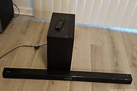 Soundbar, subwoofer, remote group shot