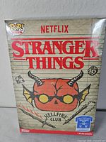 Front of sealed Funko Pop box with Stranger Things Hellfire Club skull graphic