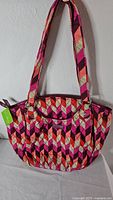 Front view of Vera Bradley quilted purse with tag attached