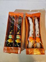 Two boxed sets of Halloween taper candles, overview