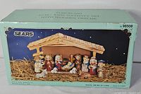 Box front showing Sears porcelain 12 pc kids nativity set model 98508