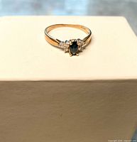 Front view showing sapphire and diamonds on yellow gold band