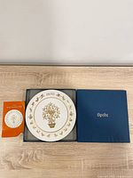 Plate inside open blue Spode box with leaflet visible