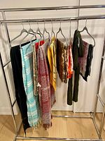 Rack showing all nine scarves hanging
