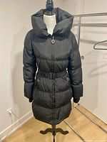 Front view of black Betsey Johnson puffer coat on mannequin