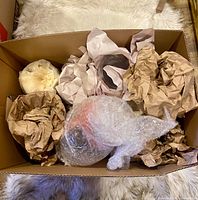 boxed lot showing packed glass pieces