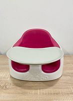 Front view showing seat, tray, magenta insert, Bumbo logo