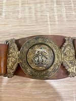 Close-up of ornate Canadian Army Medical Corps bi-metal buckle, missing lion head