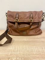 Front view folded showing handles, strap and Fossil logo patch