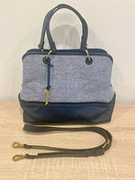 Front view of Fossil Lane handbag with strap laid out