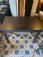 Table in compact form, scratches visible