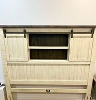 Full view of reclaimed pine queen headboard with barn doors and shelf