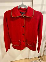 Front view hanging; shows button front, brown trim, pockets