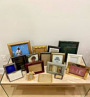 Group shot of all picture frames on glass table