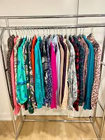 Full rack showing all 23 blouses assorted colours and prints