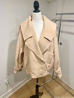Front view of cream Dino Valiano double-breasted bomber jacket on mannequin