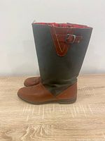 Side profile of both boots showing leather foot, canvas shaft, buckle strap