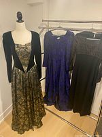 Three gowns hanging on rack