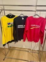 Three garments on rack, full view