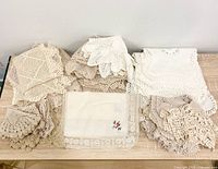 Grouped view of all crocheted doilies and linens on tabletop