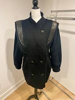 Front view of black wool double-breasted London Fog coat on mannequin