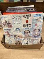 Box of LPs, front showing John Lennon “Shaved Fish” cover