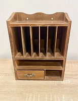 Front view showing six slots, shelf and drawer