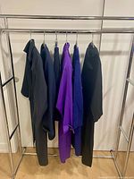 Full rack showing six wool garments on hangers