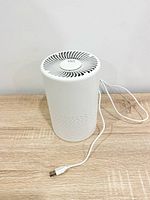 Front view of white Vio air purifier with attached USB cord