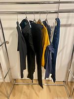 Rack with all six garments showing variety of colors and styles