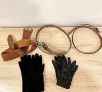 Overview of 3 belts and 2 pairs gloves on table