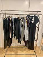 Full rack showing all 23 clothing pieces on hangers