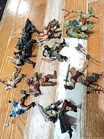 Group shot of all 10 medieval fantasy action figures on wooden floor