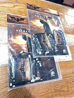 Two sealed Batman Begins sticker album packs in original plastic