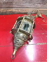 Full view of brass lantern lamp showing stained glass panels and wiring